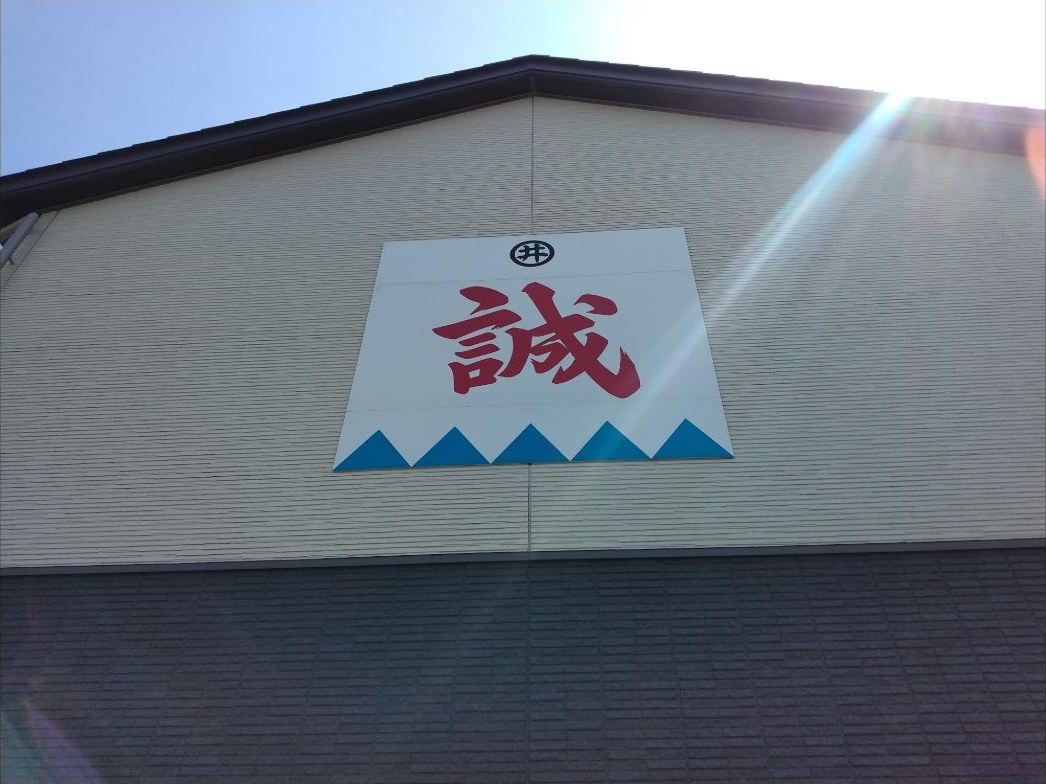資料館の建物に掲げられた「誠」の看板。上に井上家の「井」の印が見えます。