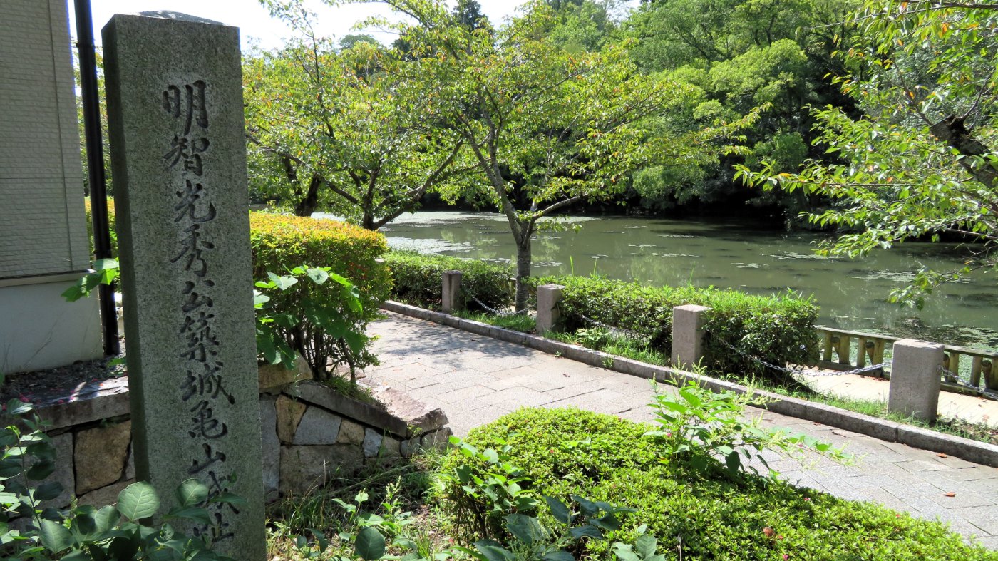 「明智光秀公築城亀山城址」の石柱と南郷池